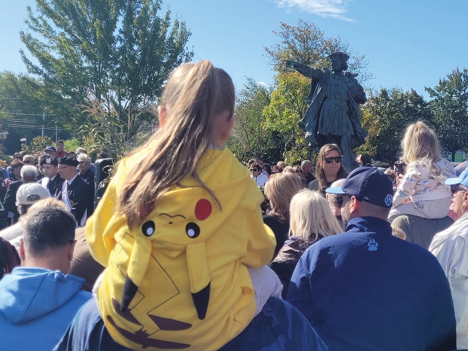 PIKACHU PEEK: Youngsters climbed onto shoulders for a glimpse of Johnston’s new Christopher Columbus statue.